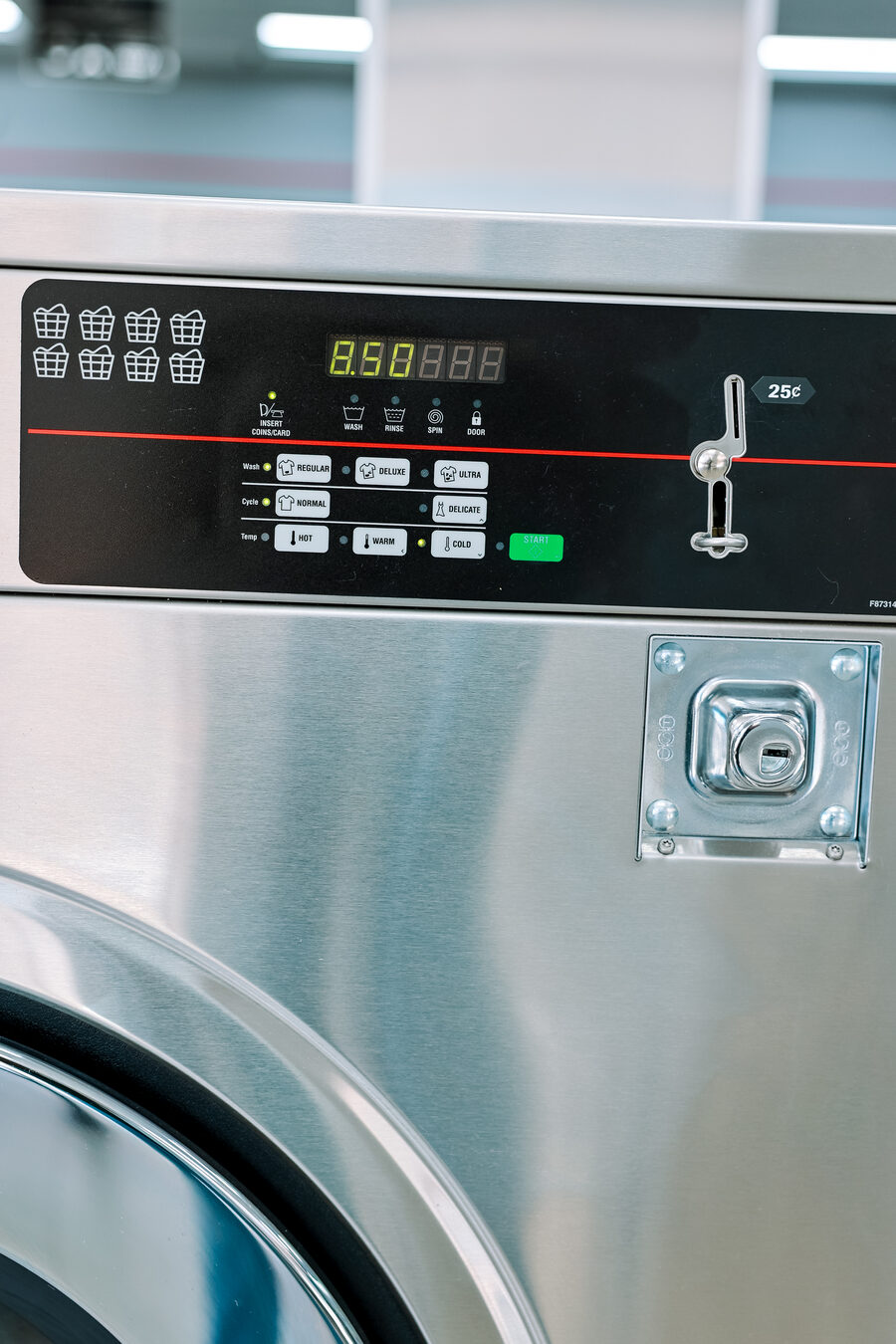 Washer coin slot accepting quarters at Clean Queen Laundry