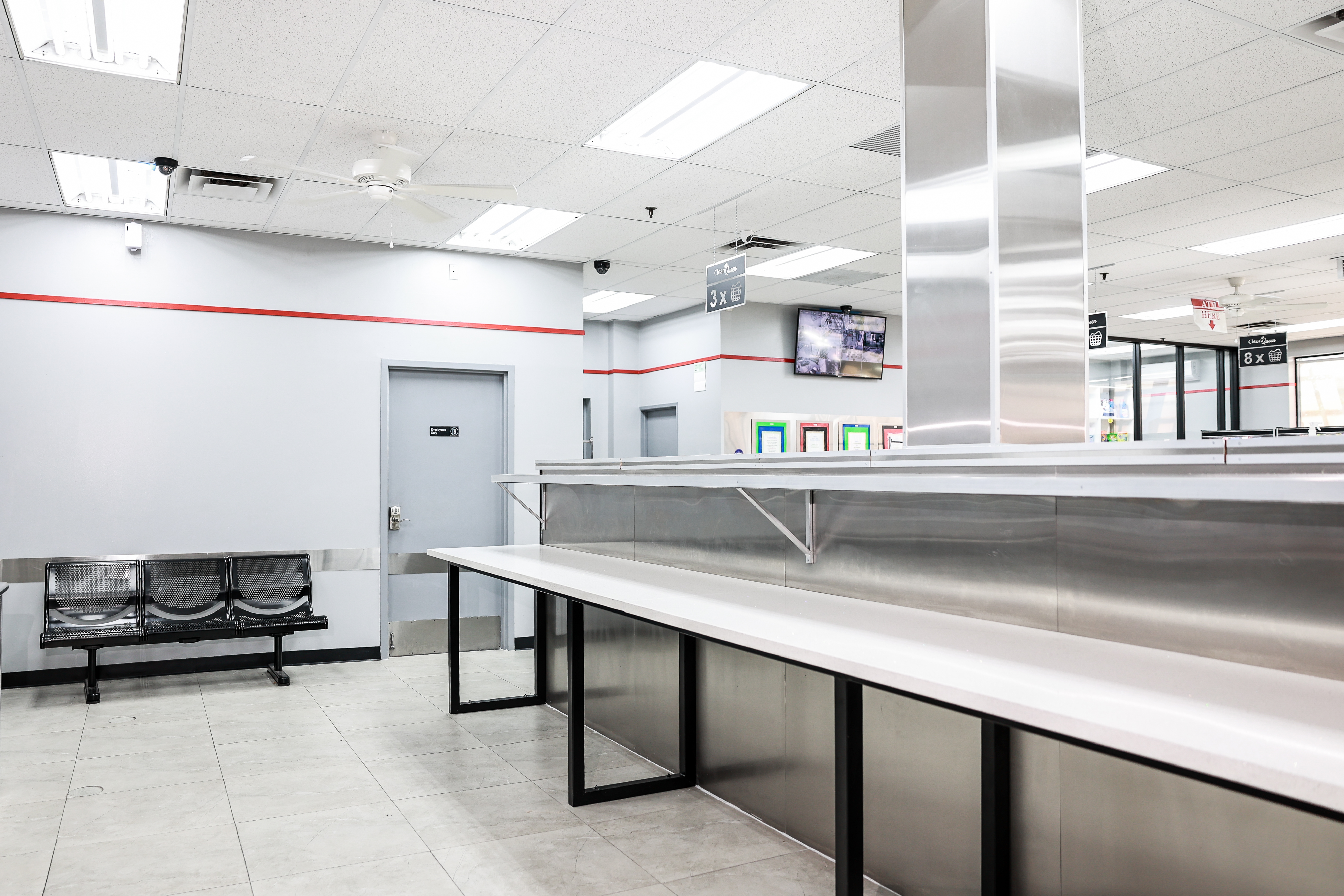 Stainless steel folding stations and seating area at Clean Queen Laundry