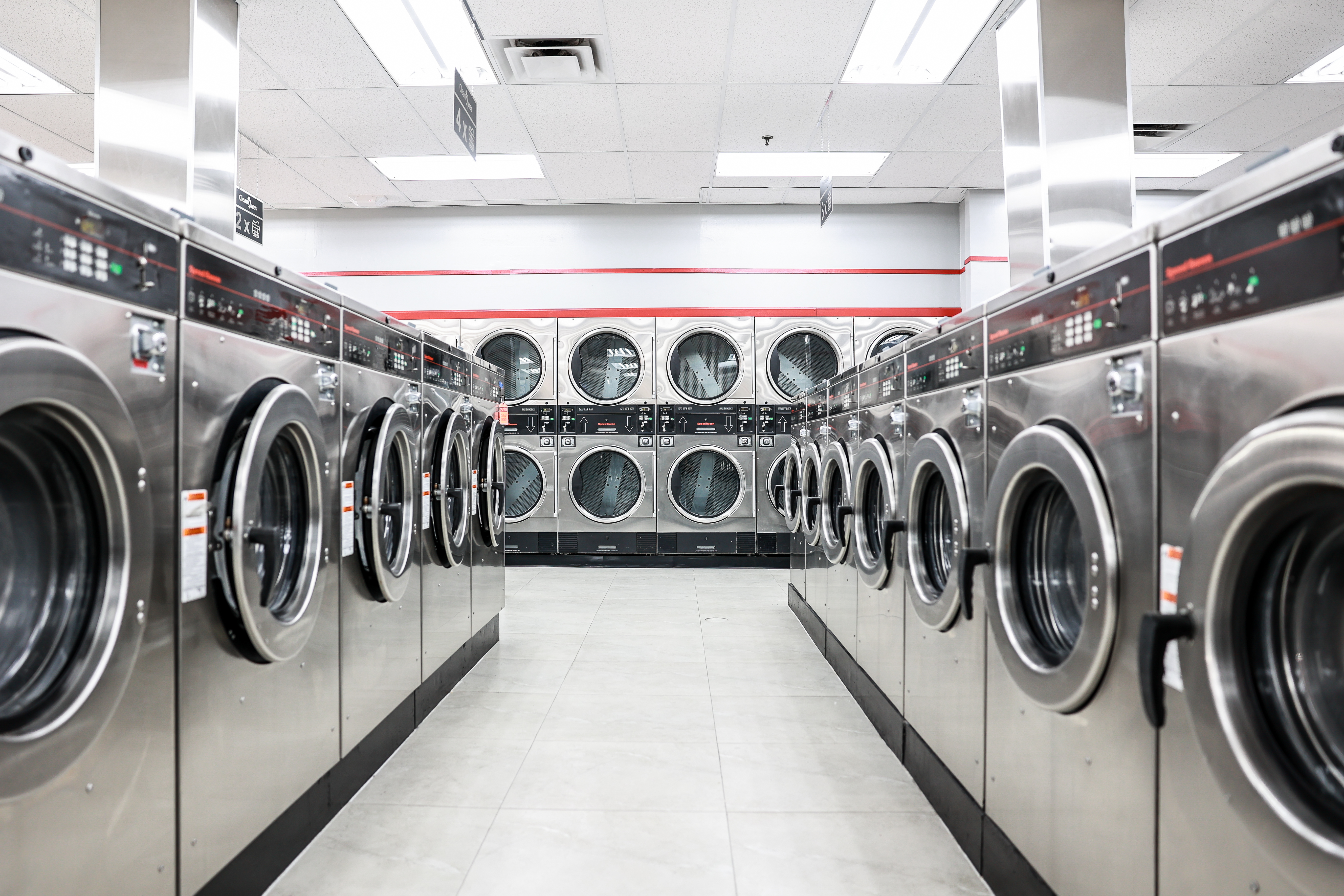 Rows of clean front-load washers and dryers at Clean Queen Laundromat in Lincoln Heights